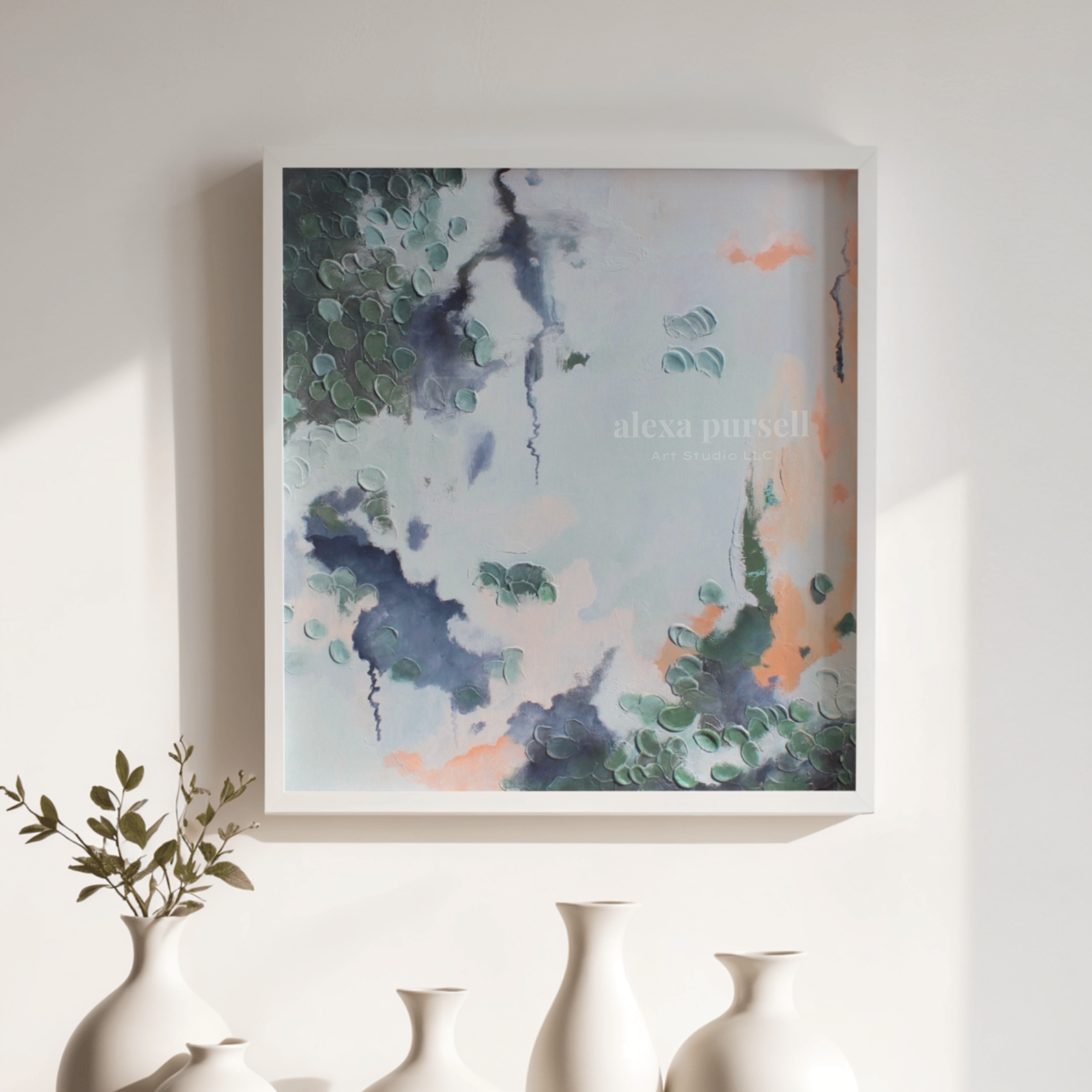 Table with abstract style paintings, paint, and brushes.